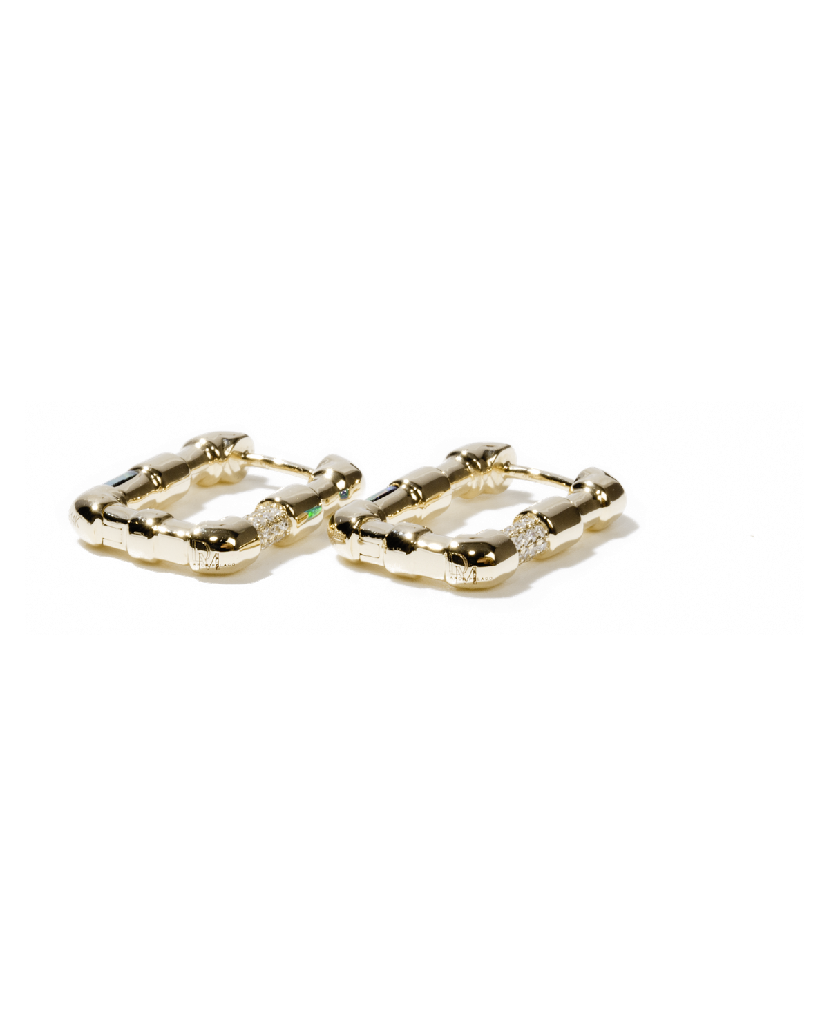 The finished gold hoop earrings, set with diamonds and opal.
